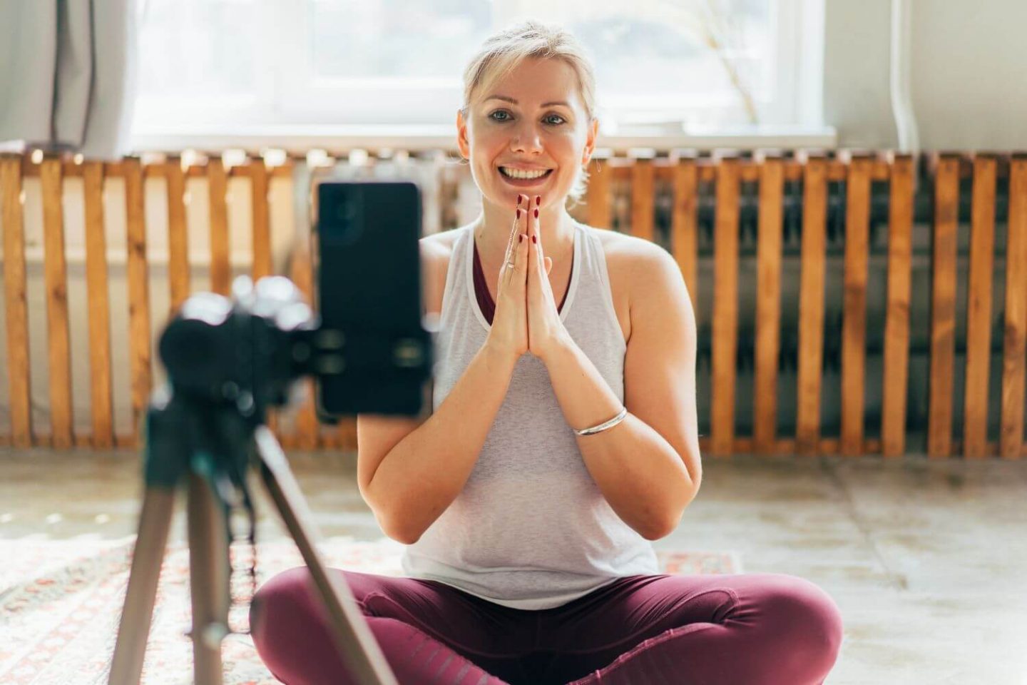 Woman filming yoga class, best yoga studio software
